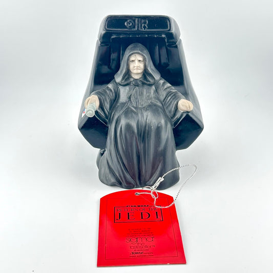 Decorative figurine of a character in a hooded robe with a red tag on a white background