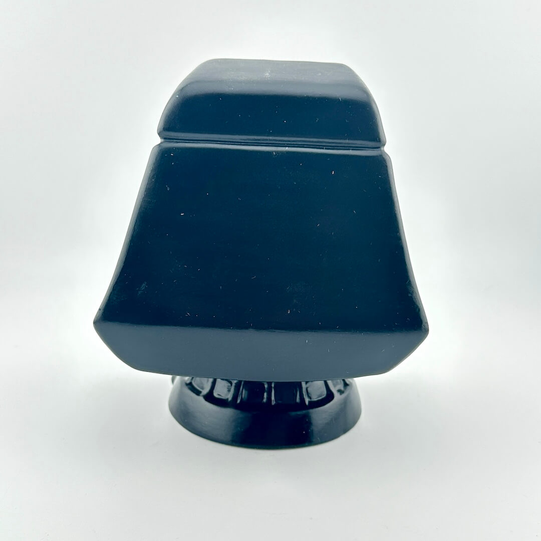 Ceramic figurine of the Star Wars Emperor in throne against white background. 