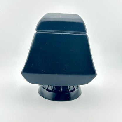 Ceramic figurine of the Star Wars Emperor in throne against white background. 