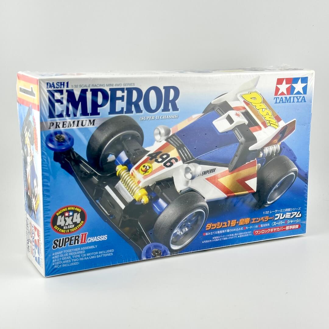 Tamiya DASH1 Emperor Premium RC car chassis model kit box, featuring a blue, white, and red racing car illustration.