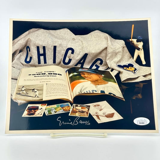 Photograph of memorabilia collage featuring signature of player, JSA authentication sticker in corner. 