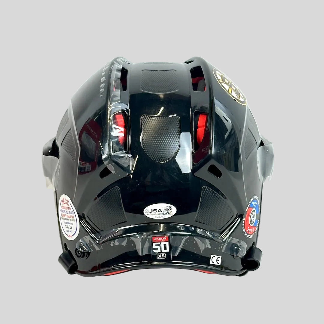 Black hockey helmet with visible branding on a white background