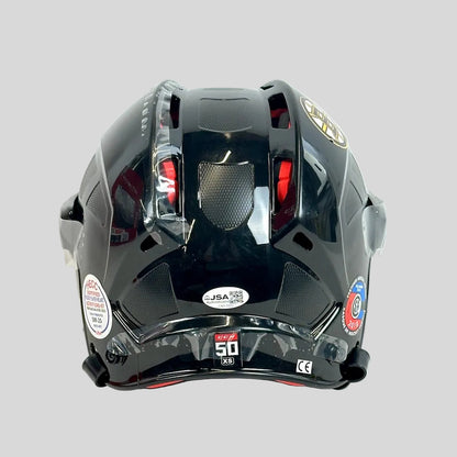 Black hockey helmet with visible branding on a white background