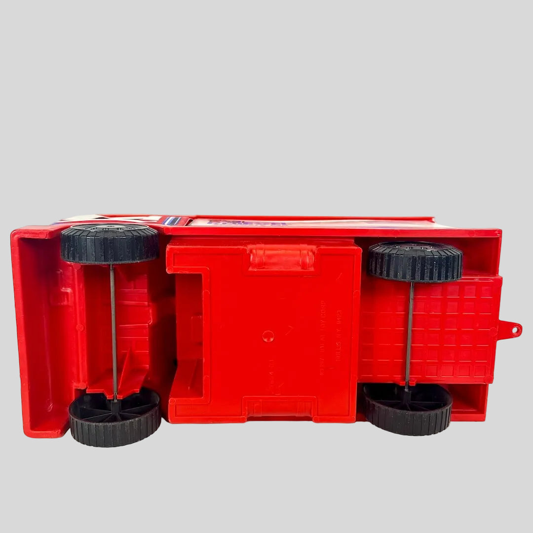 Red plastic truck with wheels on a white background