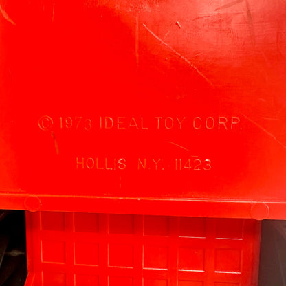 Red toy box with '© 1973 Ideal Toy Corp' branding on a red background