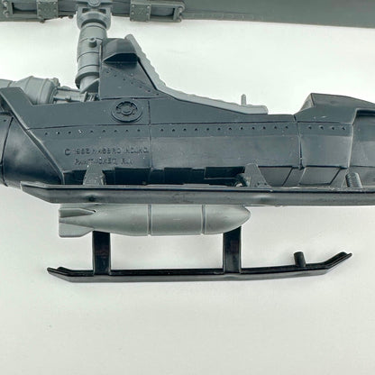 Close-up of a toy helicopter showing the manufacturing information on a white background