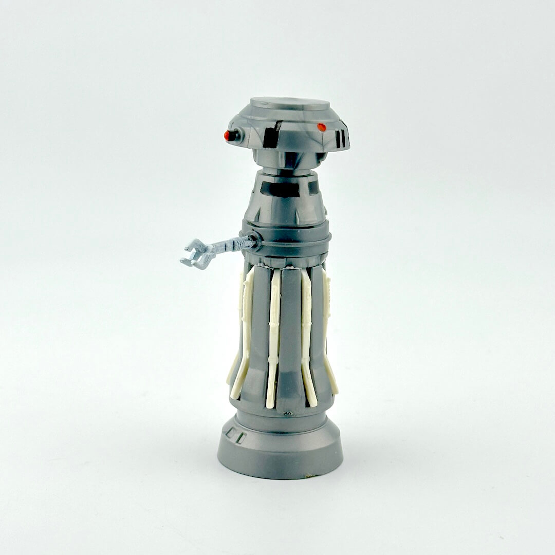 Gray toy robot figure on a white background. 