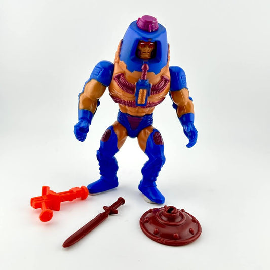 White male figure in blue armor pieces & helmet, with purple details & tubing. Pictured with three accessories.