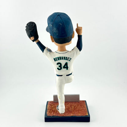 Baseball bobblehead figure with a white uniform and blue cap on a white background