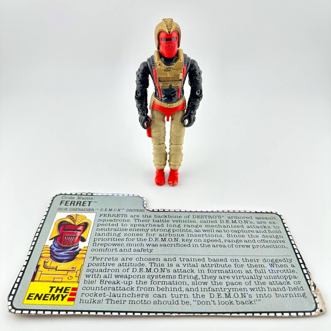 Action figure with a card detailing its features on a white background