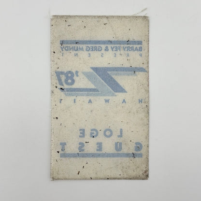 Backside of white fabric event pass with ghost image of other side visible. 