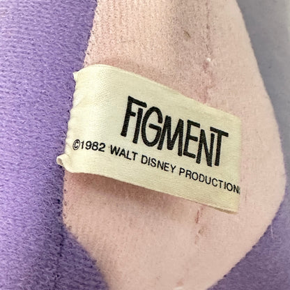 Label on a plush toy with 'Figment' and 'Walt Disney Productions' text, set against a purple and gray background.