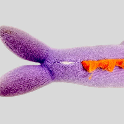 Purple plush toy with orange spine on a white background