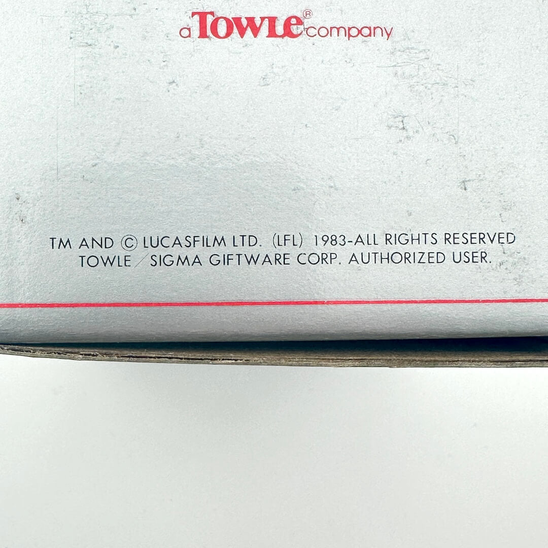 Back of a product with 'Towle Company' branding and legal text.