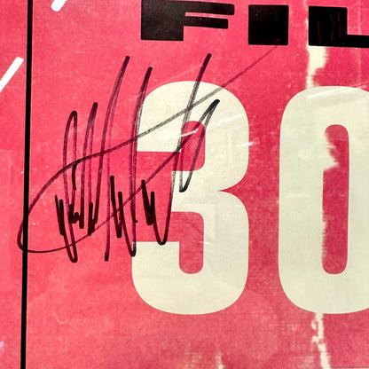 Close-up of a red and black poster packaging with 'FILTER' text and black signature. 