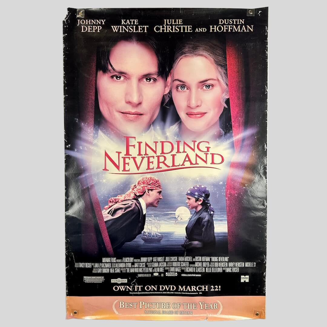 Movie poster for 'Finding Neverland' with two people's faces and a ship in the background.