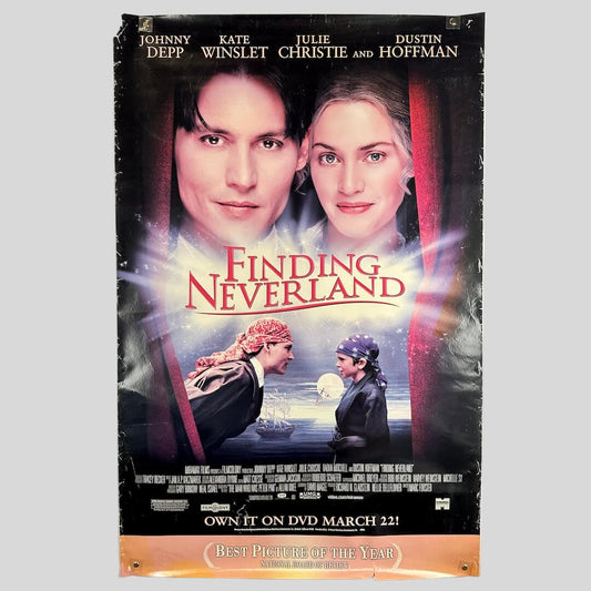 Movie poster for 'Finding Neverland' with two people's faces and a ship in the background.