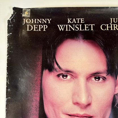 Vintage movie poster with a close-up of a person's face and actor names. Torn corner with wear to edges. 