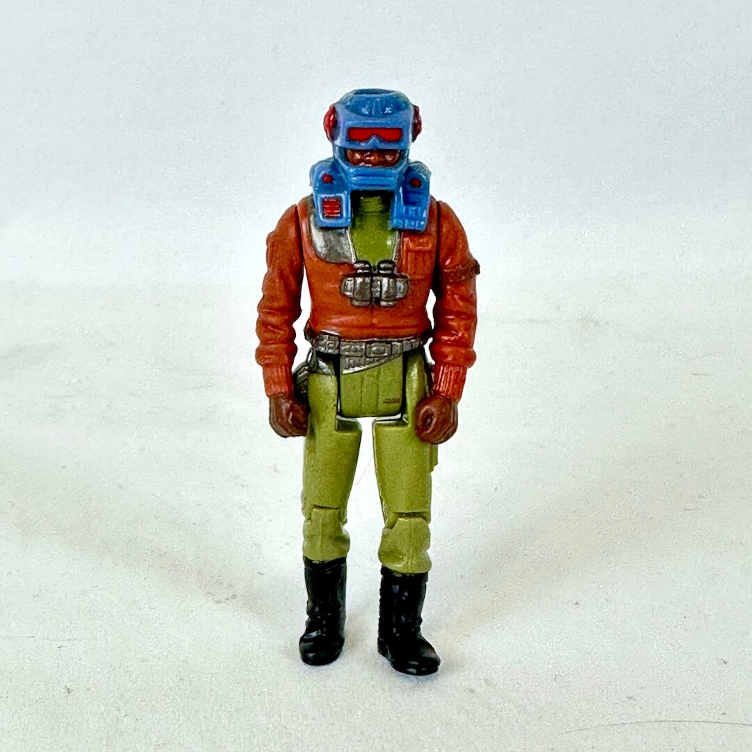 A vintage action figure in brown and green wearing blue helmet. 