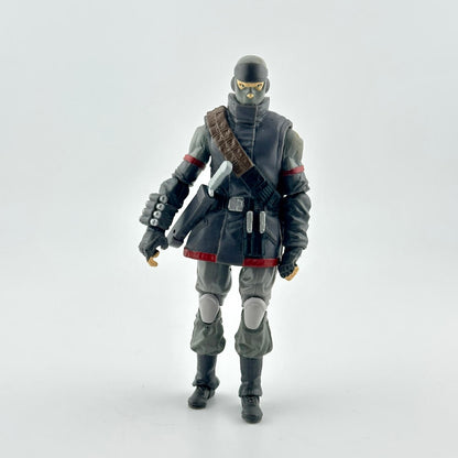 A toy action figure of a futuristic ninja soldier standing against a light gray background. 