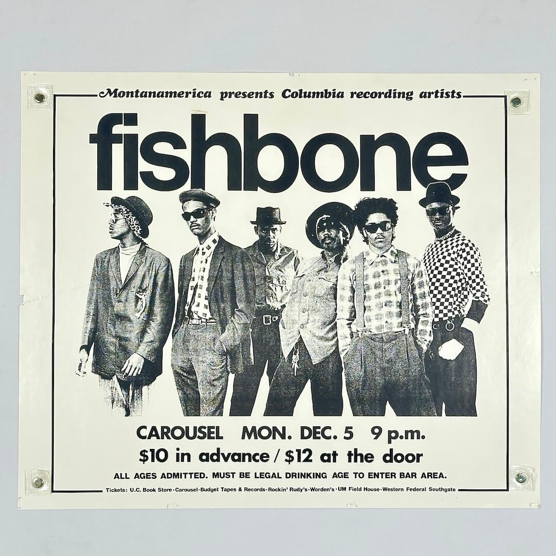 Black and white concert poster with photo of Fishbone at center surrounded by black text. 
