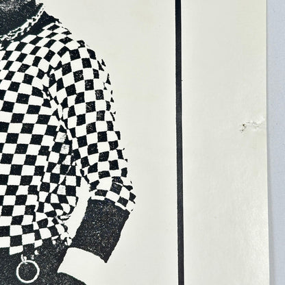 Mid-right side of poster with pin holes. 