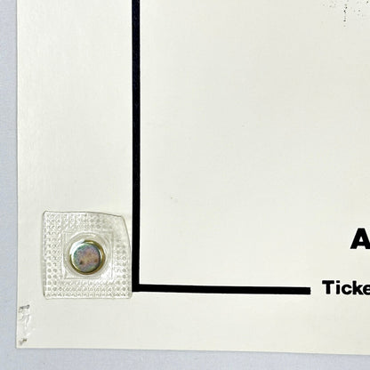 Bottom left corner of poster with pin holes. 