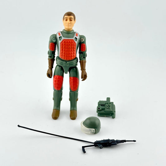 Toy figure in green and red outfit with accessories on a white background