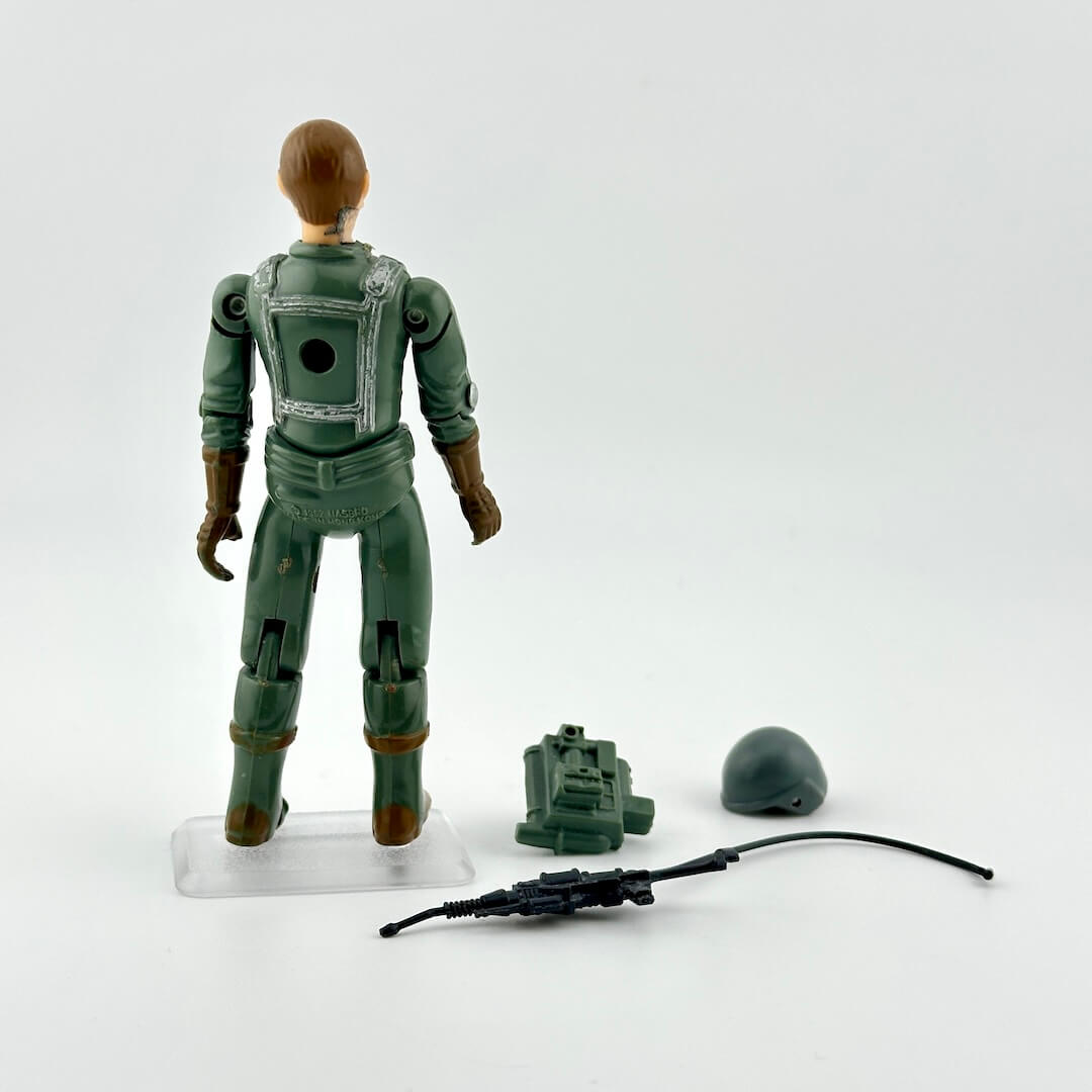 GI Joe action figure with accessories against white background. 