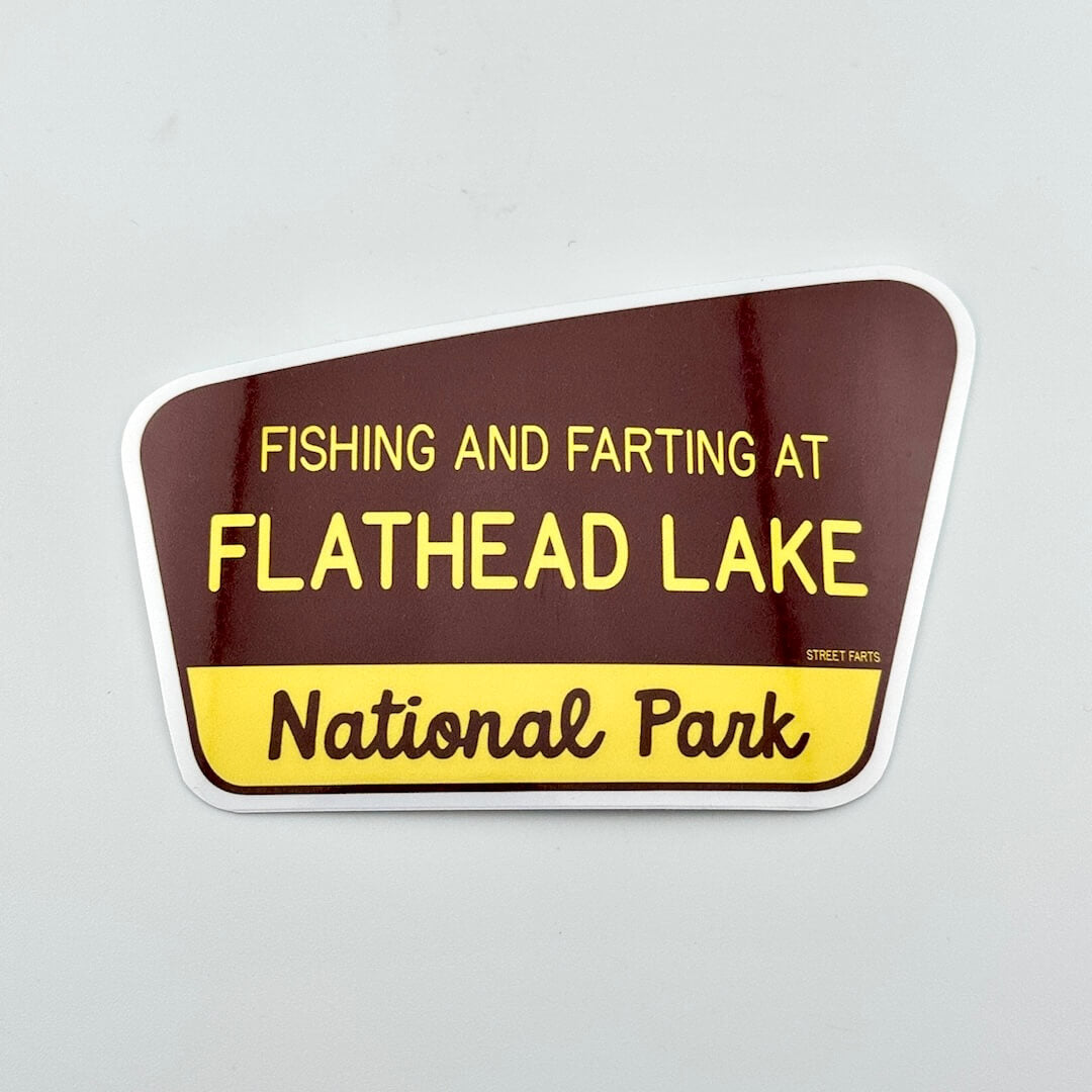 Sticker with text 'Fishing and farting at Flathead Lake National Park' on a brown and yellow background