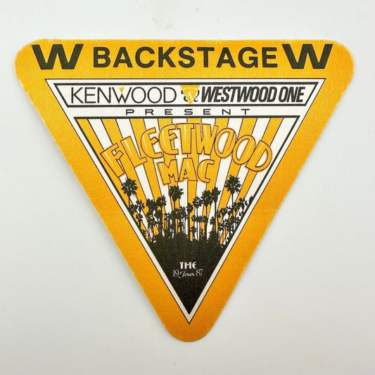 Triangular backstage pass for Fleetwood Mac concert featuring Kenwood Westwood One on a white background