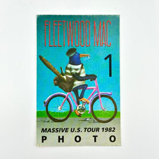 Photo pass featuring image of bird wearing clothes on bicycle under 'Fleetwood Mac' with other details along bottom. 