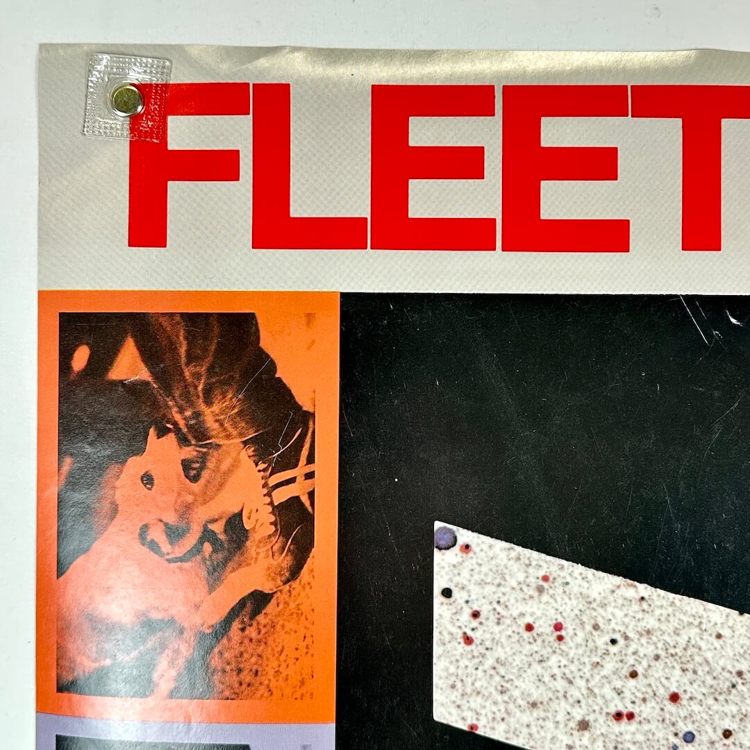 Top left corner of poster showing some edge wear and light scratches