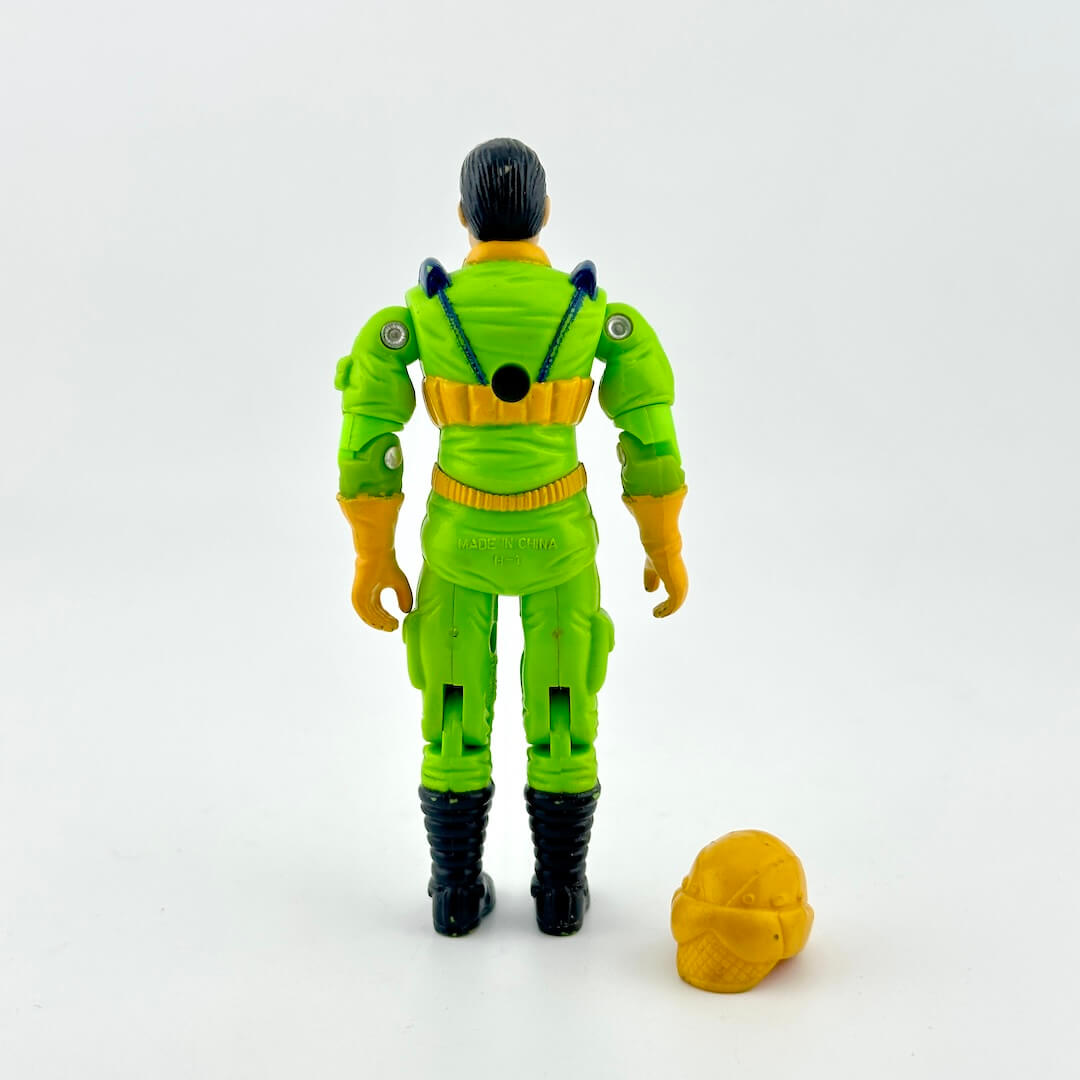 GI Joe action figure in green flight suit with yellow accents and yellow helmet, photographed on white background. 