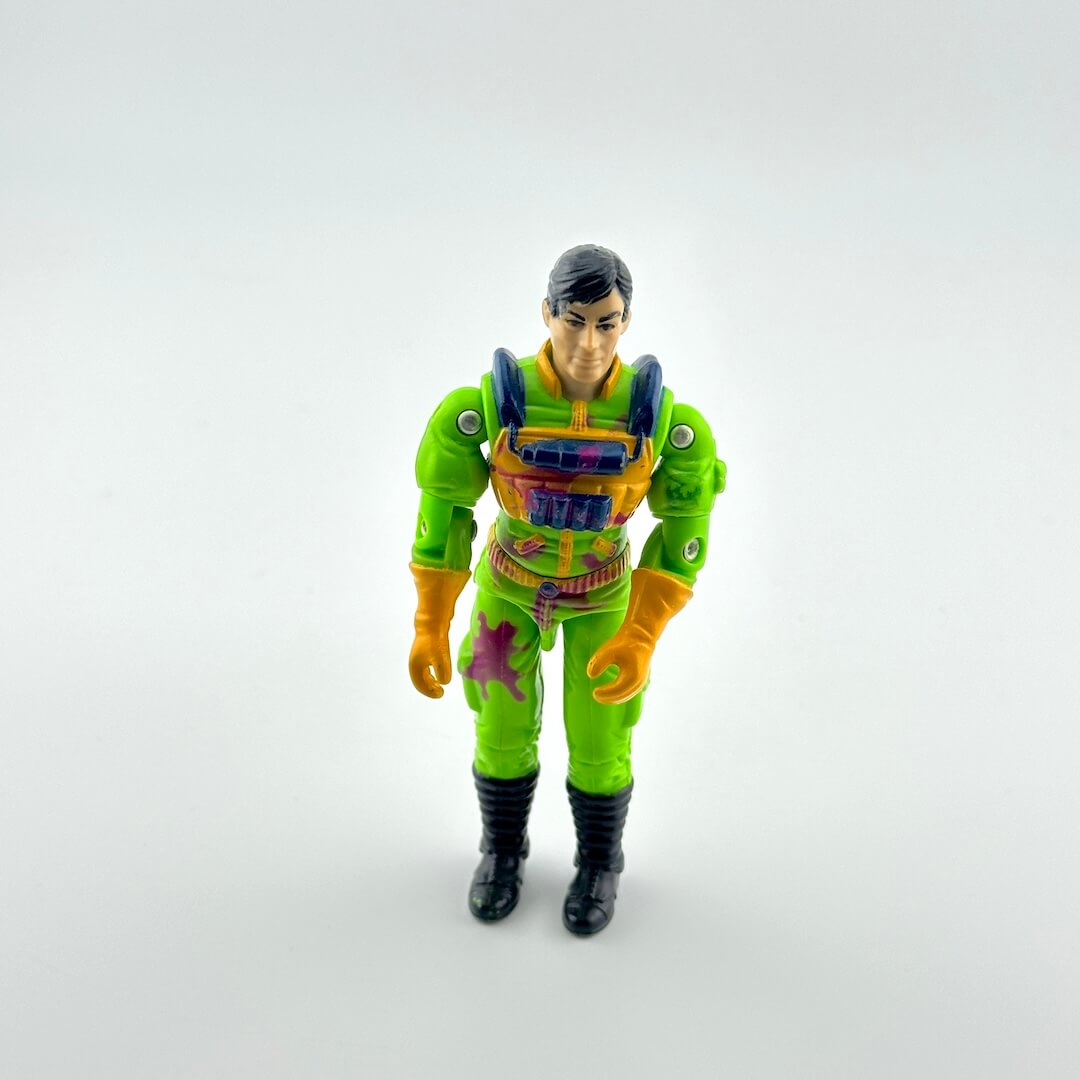Toy figure in a green and orange outfit on a white background
