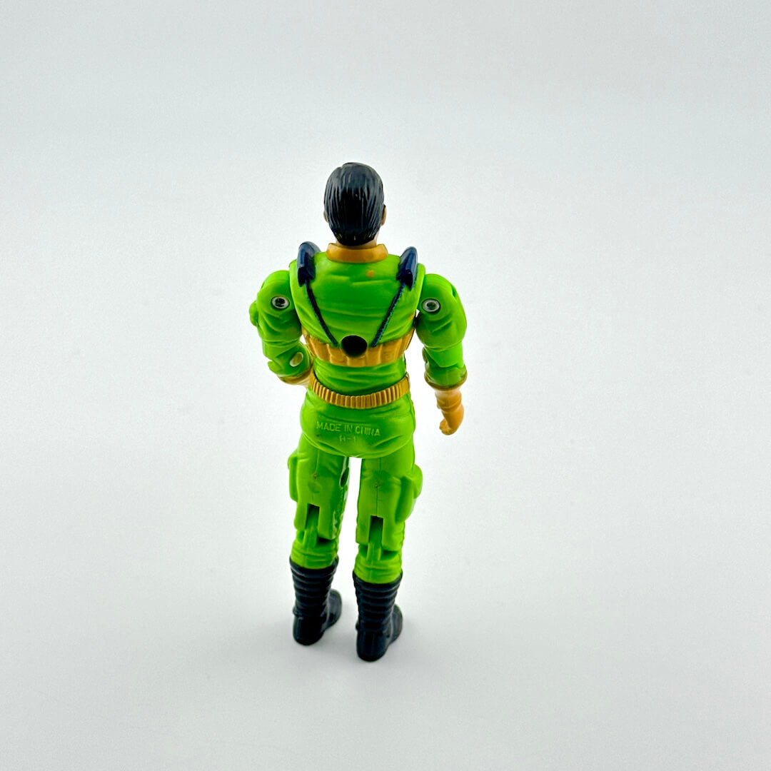 Toy figure in a green suit with black hair on a white background