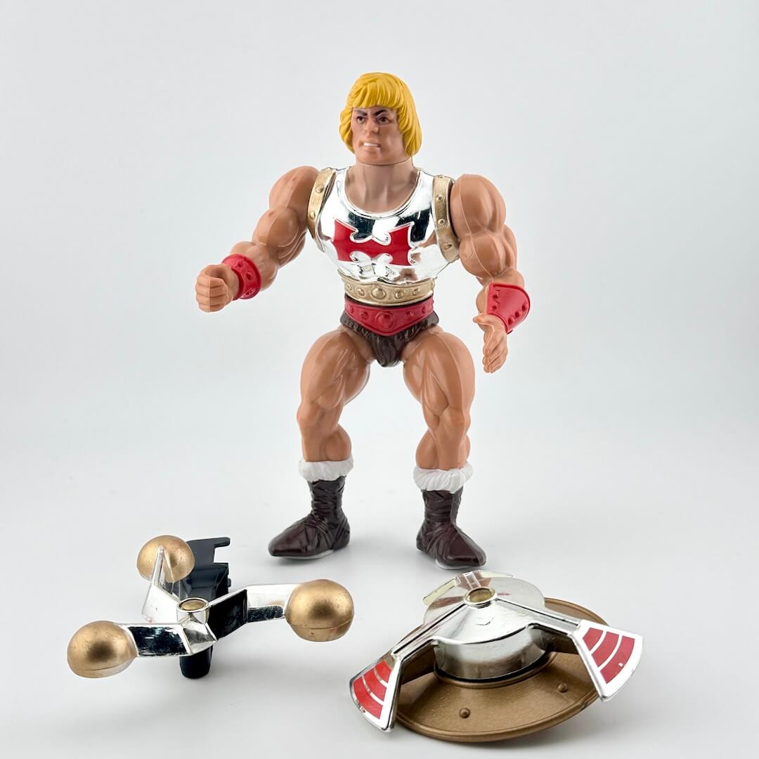 Action figure with a silver armor featuring red and black designs, standing on a white background.