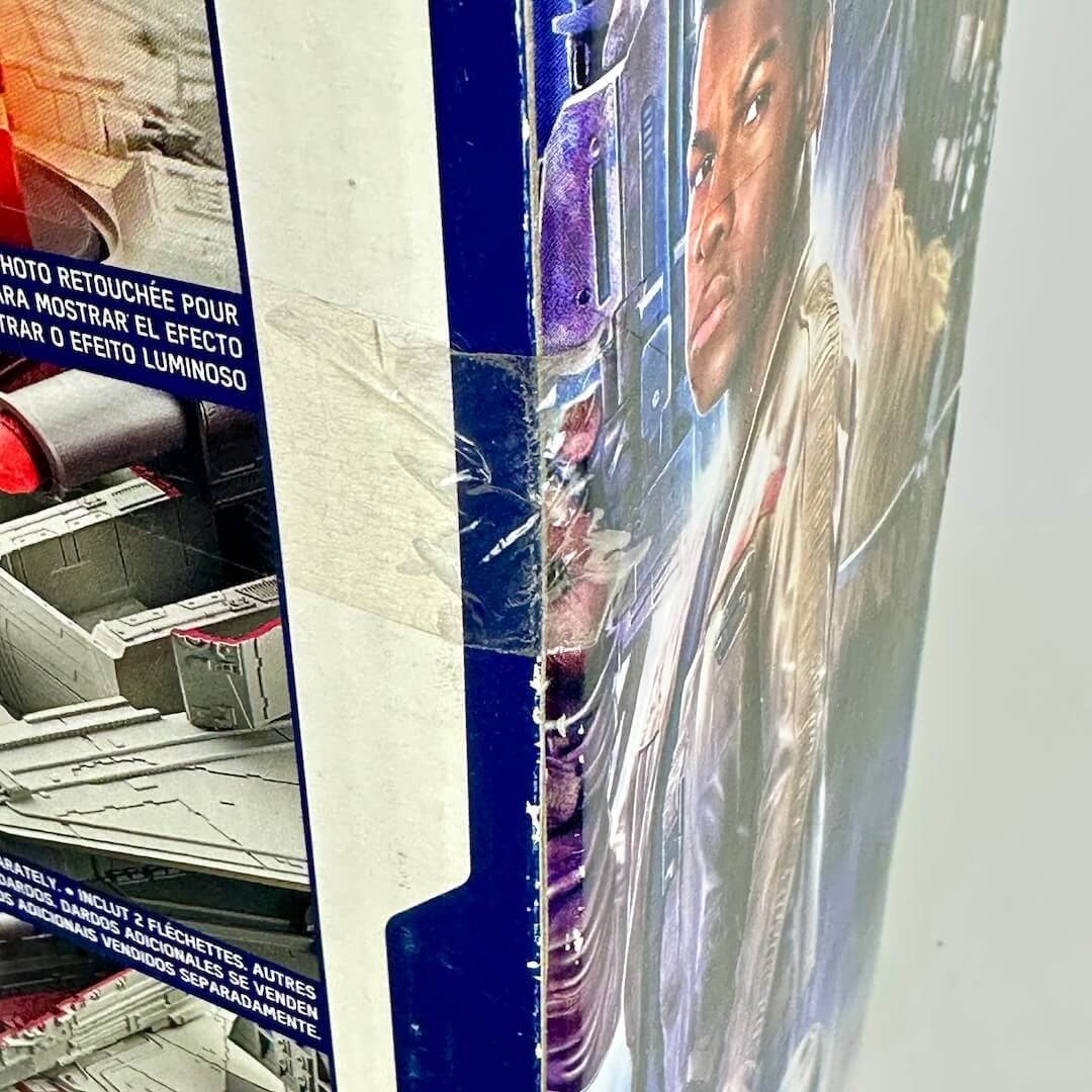 Close-up of intact factory tape seal on one side of packaging, image of characters visible.