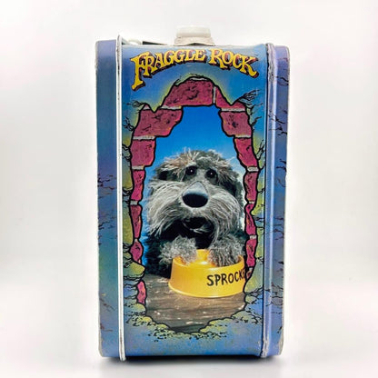Side view of vintage metal lunchbox with Sprocket from Fraggle Rock pictured with blue background. 