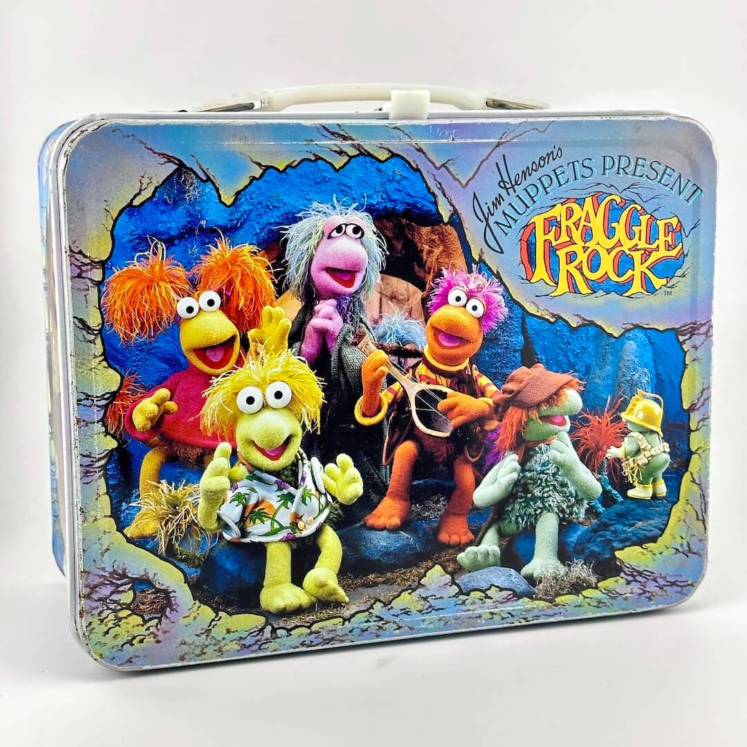 Vintage lunchbox featuring images of puppets from Fraggle Rock show. 