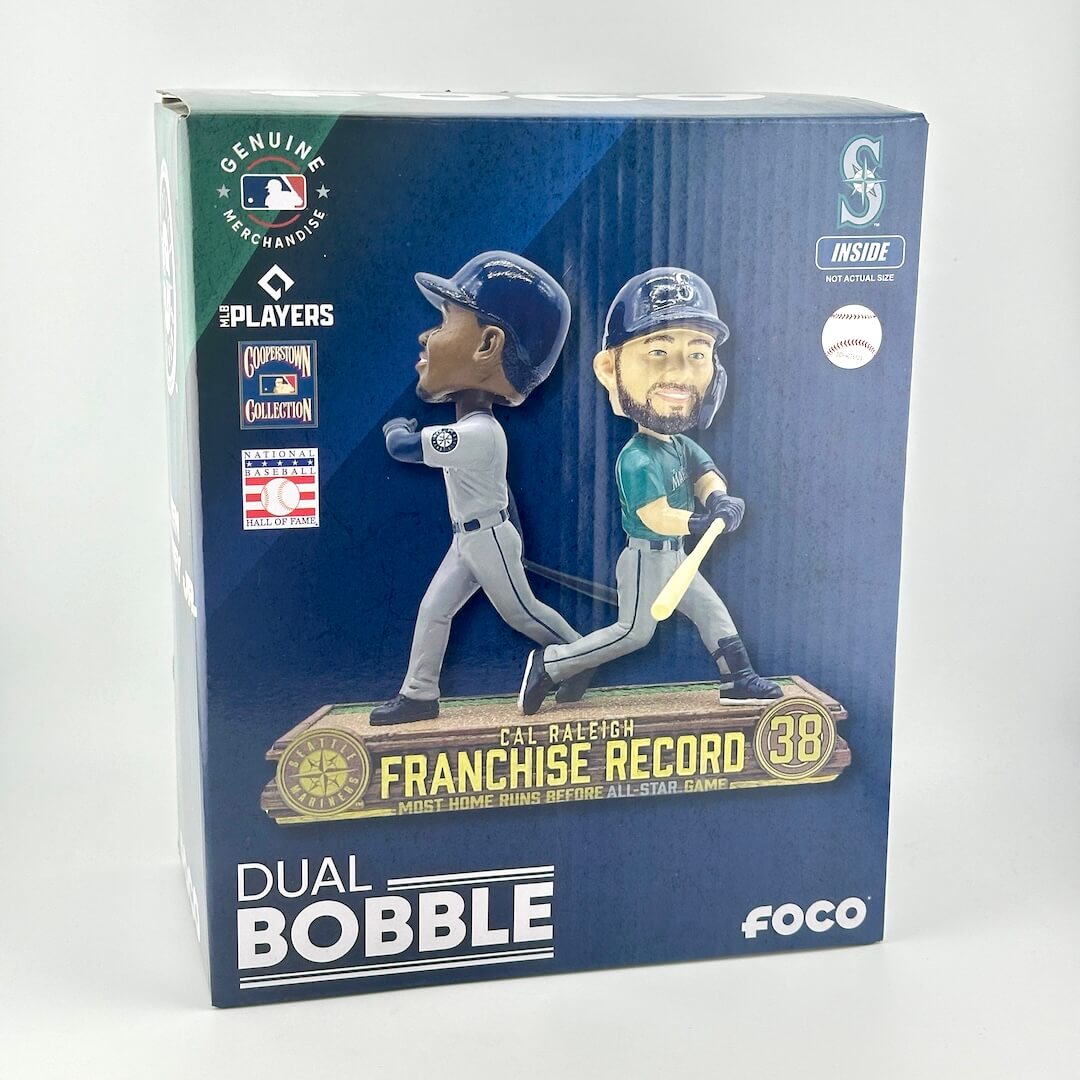 The retail packaging shows two baseball figurines on a dark blue background with team logos and product text.