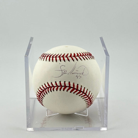 Autographed baseball in plastic cube with sticker label along bottom. Half of cube removed to show clear signature.