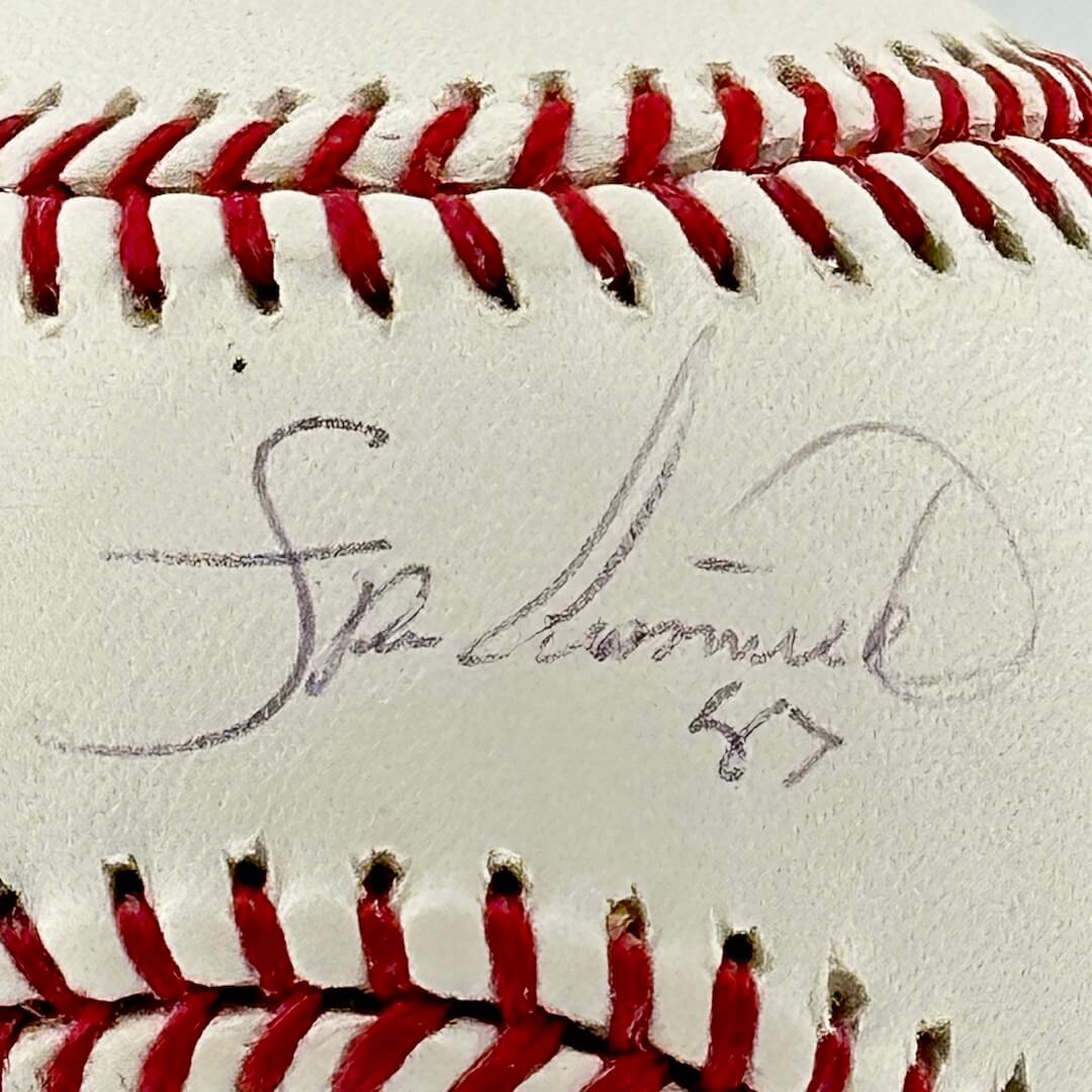 Close up of black pen signature in narrow section between red stitching, the "sweet spot. "
