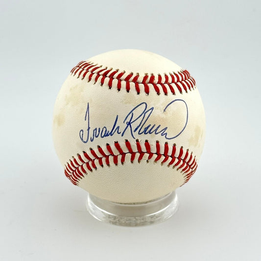 Baseball with autograph on a clear stand against a light gray background