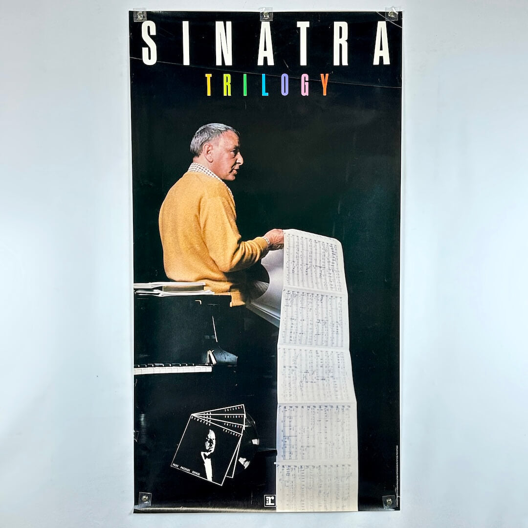 Poster of a man at a piano with 'Sinatra Trilogy' text on a black background