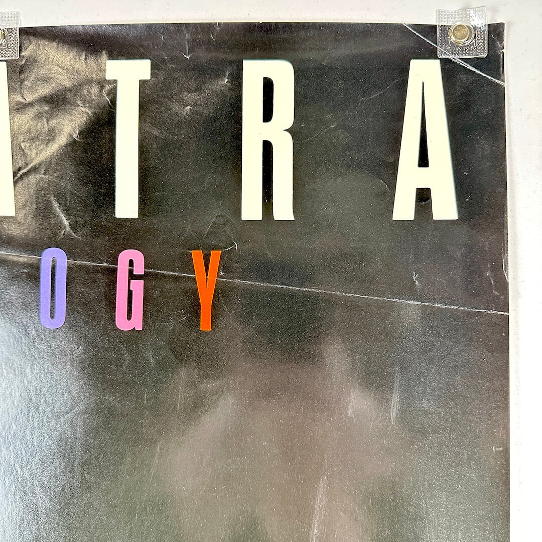 Top right corner of poster with creases and scratches.