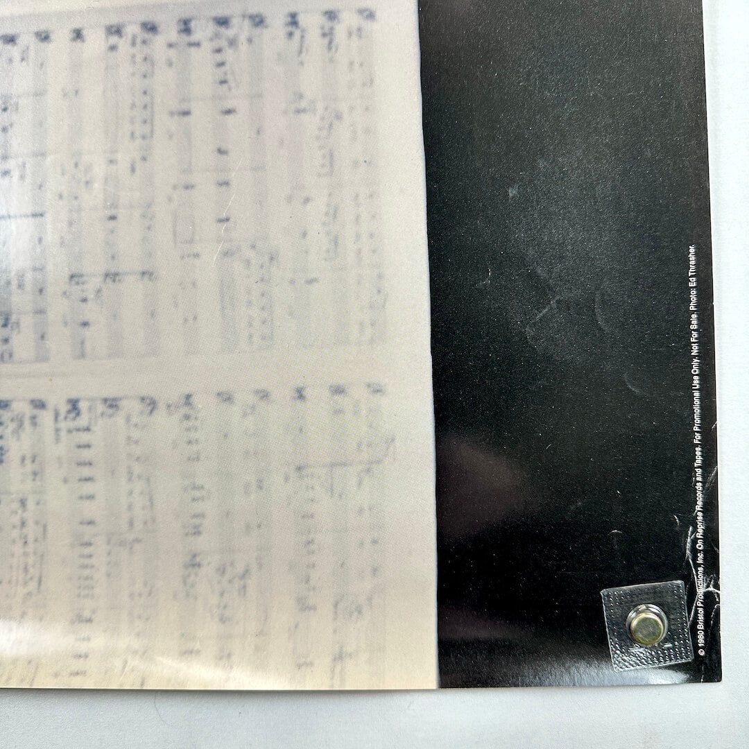 Bottom right corner of poster with edge wear and some scratches. 