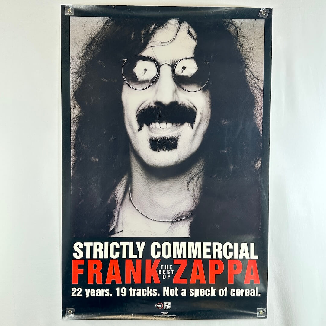 Poster of Frank Zappa with text 'Strictly Commercial' and promotional information.