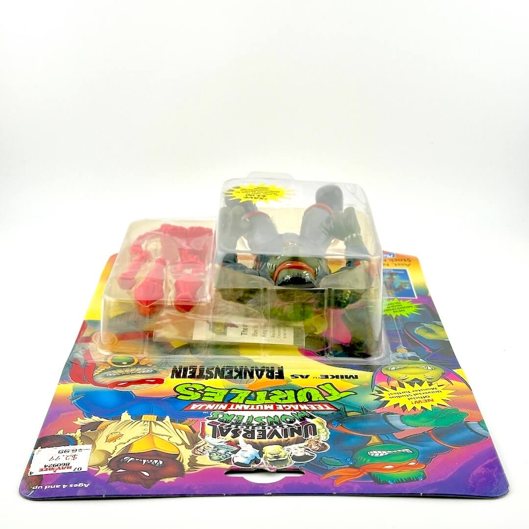 Toy figure in clear packaging on a colorful display card with branding.