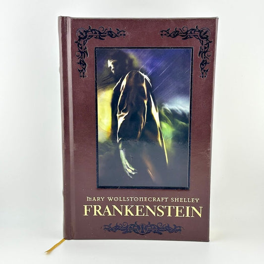Book titled 'Frankenstein' by Mary Wollstonecraft Shelley with a dark cover and text.